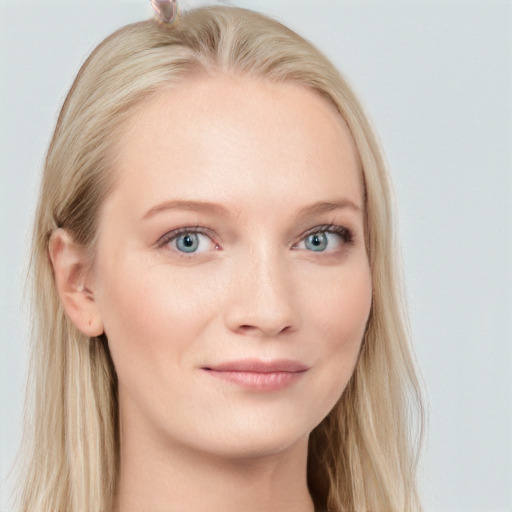 Joyful white young-adult female with long  brown hair and blue eyes