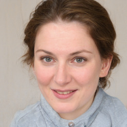 Joyful white young-adult female with medium  brown hair and blue eyes