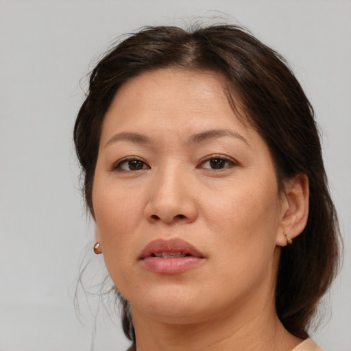 Joyful white adult female with medium  brown hair and brown eyes