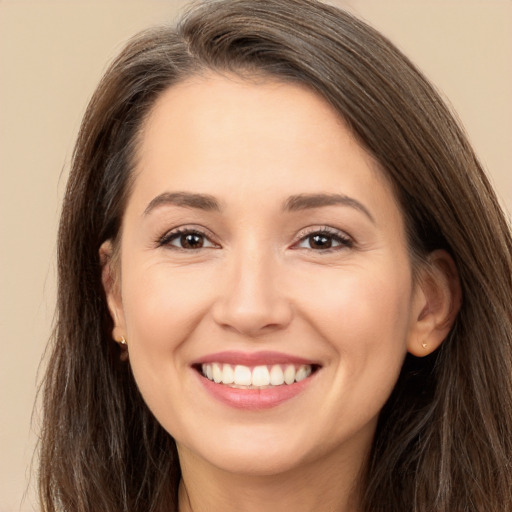 Joyful white young-adult female with long  brown hair and brown eyes