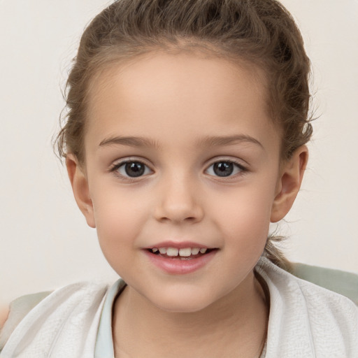 Joyful white child female with short  brown hair and brown eyes