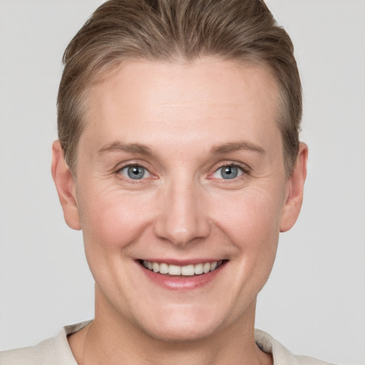 Joyful white adult female with short  brown hair and grey eyes