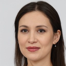 Joyful white adult female with long  brown hair and brown eyes