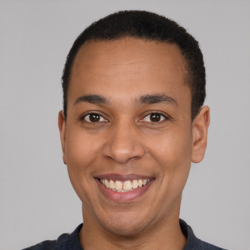 Joyful latino adult male with short  black hair and brown eyes