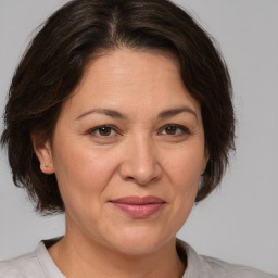 Joyful white adult female with medium  brown hair and brown eyes