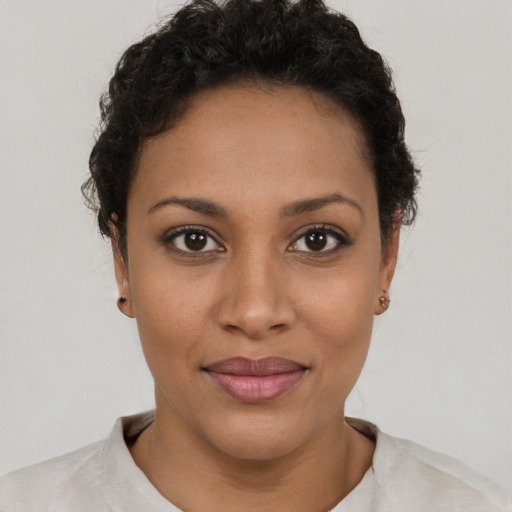 Joyful latino young-adult female with short  brown hair and brown eyes