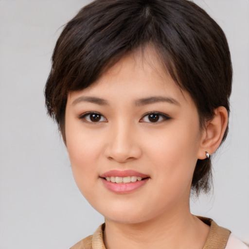 Joyful white young-adult female with medium  brown hair and brown eyes