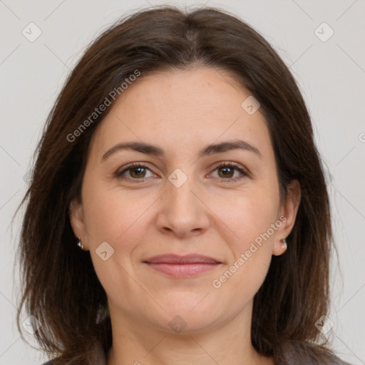 Joyful white adult female with medium  brown hair and brown eyes