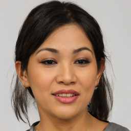 Joyful asian young-adult female with medium  brown hair and brown eyes