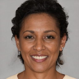 Joyful black adult female with medium  brown hair and brown eyes