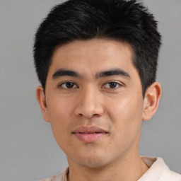 Joyful asian young-adult male with short  black hair and brown eyes