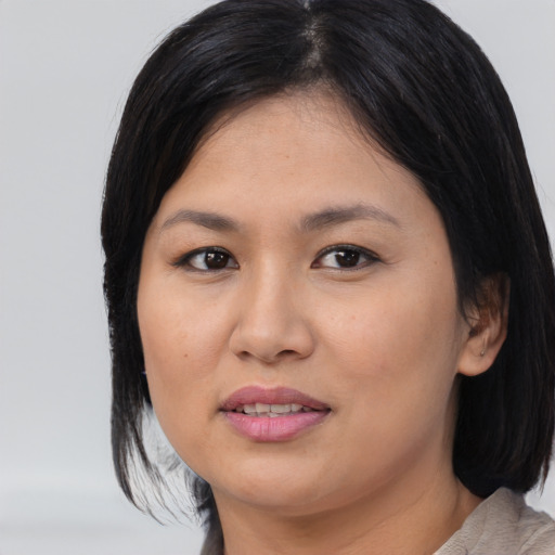 Joyful asian young-adult female with medium  black hair and brown eyes