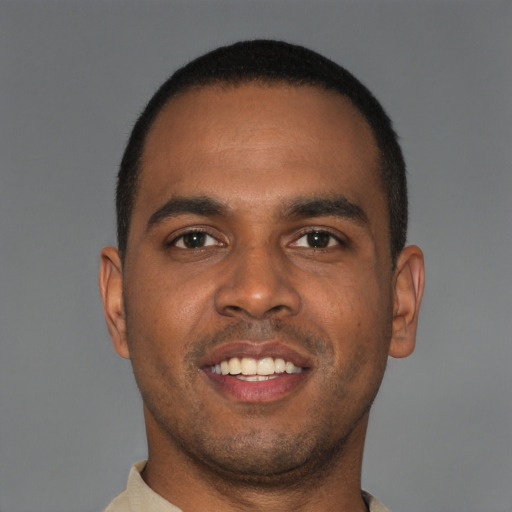 Joyful black young-adult male with short  brown hair and brown eyes