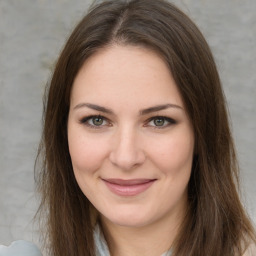 Joyful white young-adult female with long  brown hair and green eyes