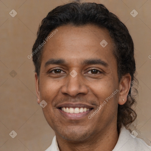 Joyful latino adult male with short  black hair and brown eyes