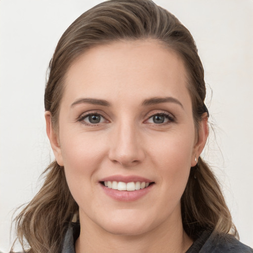 Joyful white young-adult female with long  brown hair and grey eyes