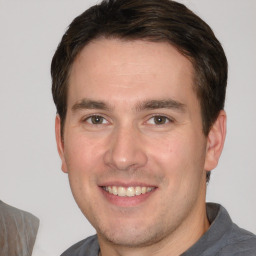 Joyful white young-adult male with short  brown hair and brown eyes