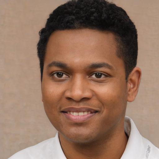 Joyful black young-adult male with short  black hair and brown eyes