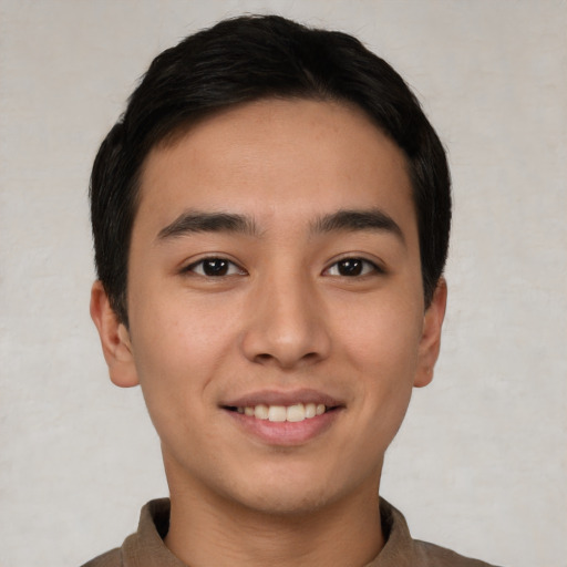 Joyful asian young-adult male with short  brown hair and brown eyes