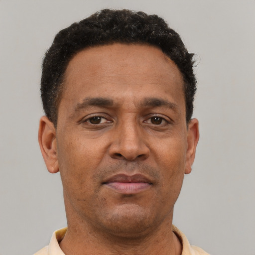Neutral latino adult male with short  brown hair and brown eyes