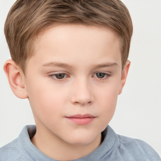 Joyful white child male with short  brown hair and grey eyes