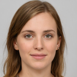 Joyful white young-adult female with long  brown hair and green eyes