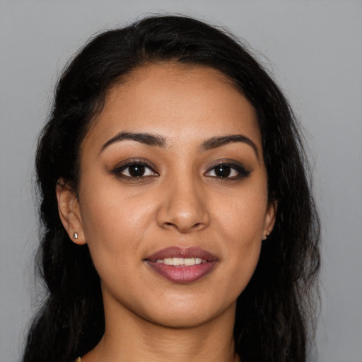 Joyful latino young-adult female with long  brown hair and brown eyes