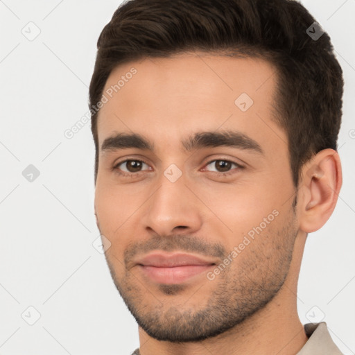 Joyful white young-adult male with short  brown hair and brown eyes