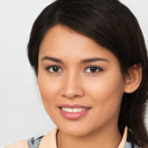 Joyful latino young-adult female with medium  brown hair and brown eyes