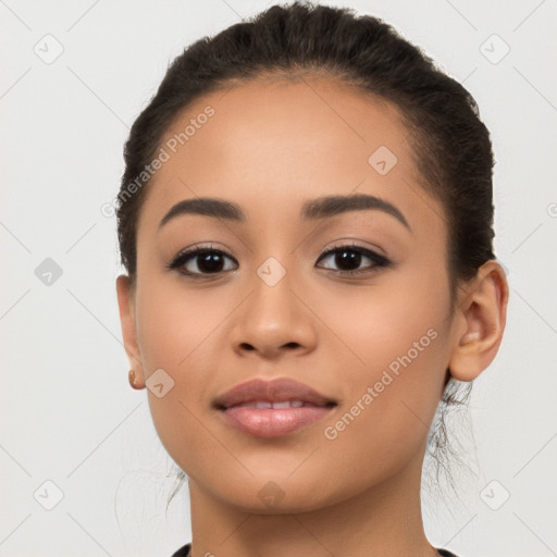 Joyful latino young-adult female with long  brown hair and brown eyes