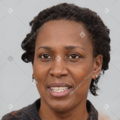 Joyful black adult female with short  brown hair and brown eyes