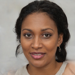 Joyful black adult female with medium  brown hair and brown eyes