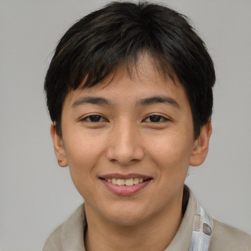 Joyful asian young-adult female with short  brown hair and brown eyes
