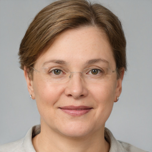 Joyful white adult female with short  brown hair and grey eyes