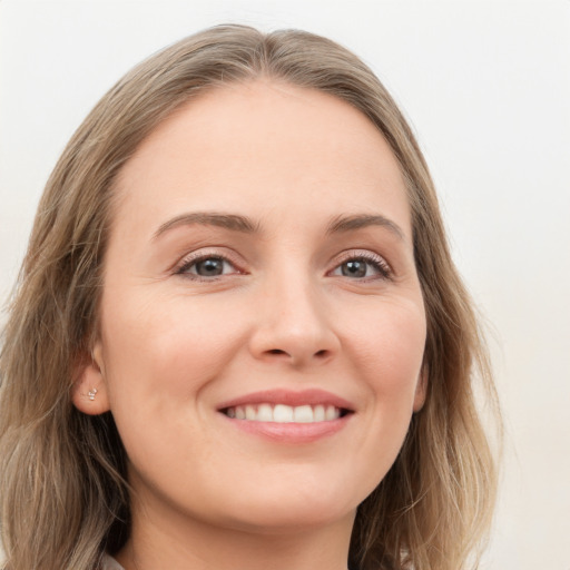 Joyful white young-adult female with long  brown hair and grey eyes