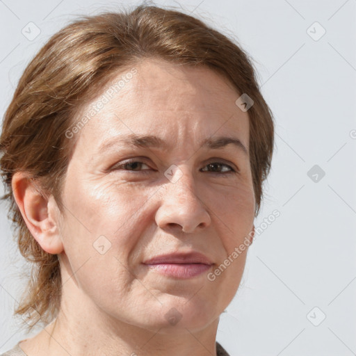 Joyful white adult female with medium  brown hair and blue eyes