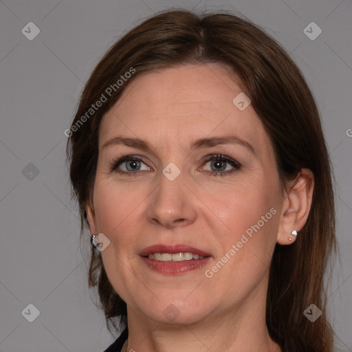 Joyful white adult female with medium  brown hair and grey eyes