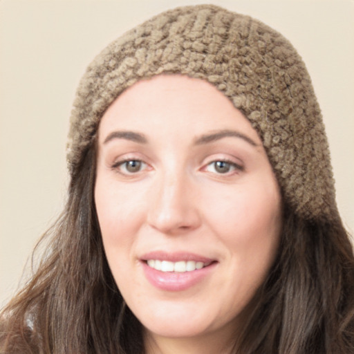 Joyful white young-adult female with long  brown hair and green eyes