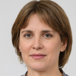 Joyful white adult female with medium  brown hair and grey eyes