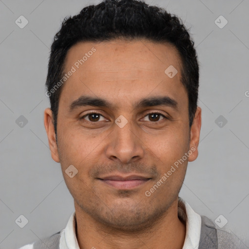 Joyful latino young-adult male with short  black hair and brown eyes