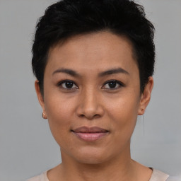 Joyful asian young-adult female with short  black hair and brown eyes