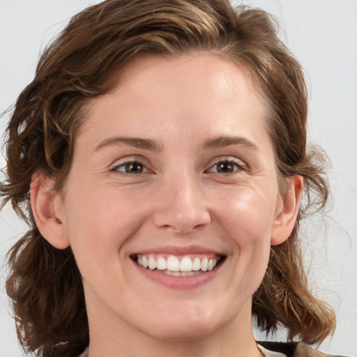 Joyful white young-adult female with medium  brown hair and blue eyes