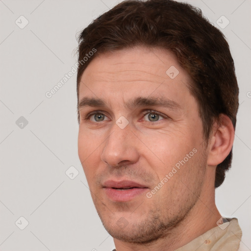 Joyful white adult male with short  brown hair and brown eyes