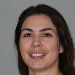 Joyful white young-adult female with medium  brown hair and brown eyes