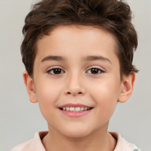 Joyful white child male with short  brown hair and brown eyes