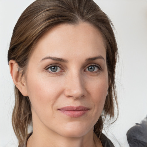 Joyful white young-adult female with medium  brown hair and grey eyes