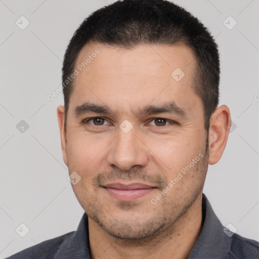 Joyful white adult male with short  brown hair and brown eyes