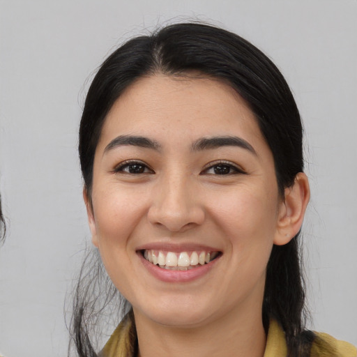 Joyful asian young-adult female with medium  black hair and brown eyes