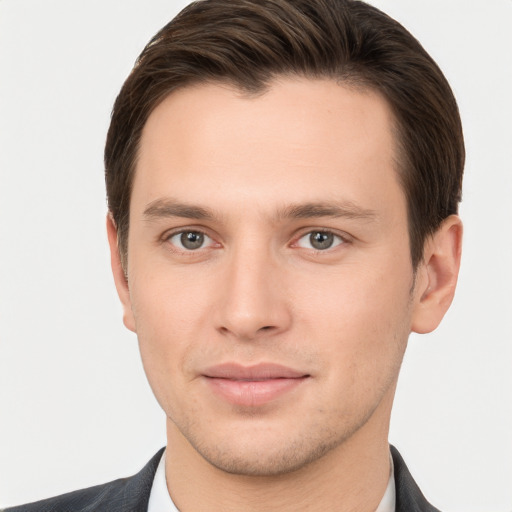 Joyful white young-adult male with short  brown hair and brown eyes