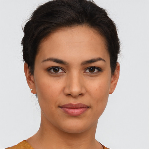 Joyful latino young-adult female with short  brown hair and brown eyes
